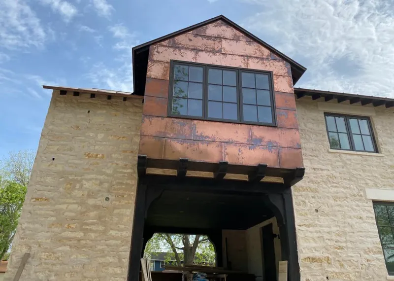 Copper metal panel facade on a stone building for Roof Repair in Chino Valley